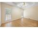 Light-filled bedroom with a ceiling fan, hardwood floors, and two large windows at 4790 Cascade Ave, Rock Hill, SC 29732