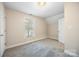 A bright bedroom featuring a window, carpet, and neutral paint at 4790 Cascade Ave, Rock Hill, SC 29732