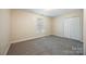 Neutral bedroom featuring a double closet, window, and carpeted floor at 4790 Cascade Ave, Rock Hill, SC 29732