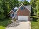 Charming brick home with a two-car garage, complemented by blue shutters and a well manicured lawn at 4790 Cascade Ave, Rock Hill, SC 29732