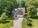 Beautiful two-story brick home with a two-car garage, blue shutters, and manicured landscaping at 4790 Cascade Ave, Rock Hill, SC 29732