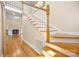 Bright foyer featuring hardwood floors, a staircase with white spindles, and fireplace view at 4790 Cascade Ave, Rock Hill, SC 29732