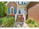 Inviting front entrance with brick steps, white railing, and a vibrant blue door at 4790 Cascade Ave, Rock Hill, SC 29732