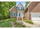 Charming two-story brick home with blue shutters, a white porch, and manicured landscaping at 4790 Cascade Ave, Rock Hill, SC 29732