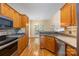 Open kitchen showcasing stainless steel appliances, wood cabinetry, and a breakfast bar overlooking a cozy living space at 4790 Cascade Ave, Rock Hill, SC 29732