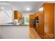 Well-equipped kitchen with stainless steel appliances, wood cabinets, and stone backsplash, ready for any chef at 4790 Cascade Ave, Rock Hill, SC 29732