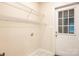 Bright laundry room with wire shelving, white walls, tile floor, and exterior door at 4790 Cascade Ave, Rock Hill, SC 29732