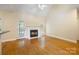 Spacious living room with vaulted ceiling, fireplace, and door to backyard at 4790 Cascade Ave, Rock Hill, SC 29732