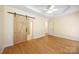 Spacious main bedroom with wood floors, open barn door to bathroom, and a ceiling fan at 4790 Cascade Ave, Rock Hill, SC 29732