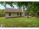 The backyard boasts a comfortable deck and a lush lawn framed by mature trees offering ample shade at 508 Long Creek Pkwy, Charlotte, NC 28214