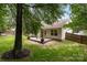 A backyard featuring a spacious deck that's perfect for relaxing under the shade of mature trees at 508 Long Creek Pkwy, Charlotte, NC 28214