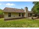 The backyard has a cozy deck, a well-maintained lawn, and mature trees providing shade at 508 Long Creek Pkwy, Charlotte, NC 28214