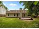 A charming backyard with a wooden deck, complemented by a well-kept lawn and mature trees at 508 Long Creek Pkwy, Charlotte, NC 28214