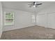Neutral bedroom with large windows, ceiling fan and double closets at 508 Long Creek Pkwy, Charlotte, NC 28214