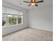 A carpeted bedroom with large window offers natural light and neighborhood views at 508 Long Creek Pkwy, Charlotte, NC 28214