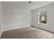 A carpeted bedroom with a large window offers natural light and backyard views at 508 Long Creek Pkwy, Charlotte, NC 28214