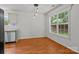 Cozy dining area features wood floors, contemporary light fixtures, and a large window at 508 Long Creek Pkwy, Charlotte, NC 28214