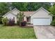 Charming one-story home boasts manicured lawn, fresh landscaping, and a two-car garage at 508 Long Creek Pkwy, Charlotte, NC 28214