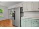 Traditional kitchen with a stainless steel refrigerator and green lower cabinets at 508 Long Creek Pkwy, Charlotte, NC 28214