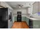Traditional kitchen with a stainless steel refrigerator and green lower cabinets and black appliances at 508 Long Creek Pkwy, Charlotte, NC 28214
