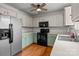 Traditional kitchen with a stainless steel refrigerator and green lower cabinets and black appliances at 508 Long Creek Pkwy, Charlotte, NC 28214