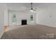 Bright and spacious living room with a fireplace, ceiling fan, and a glass patio door at 508 Long Creek Pkwy, Charlotte, NC 28214