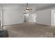 Spacious living room features neutral carpet, a ceiling fan, and lots of natural light at 508 Long Creek Pkwy, Charlotte, NC 28214