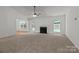 Spacious living room boasts a cozy fireplace, neutral carpet, and ample natural light at 508 Long Creek Pkwy, Charlotte, NC 28214