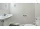 Neutral half-bath includes a pedestal sink, white toilet, and a matching wall-mounted mirror with lighting at 628 Highland Ridge Rd, Mooresville, NC 28115