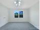Cozy bedroom featuring plush carpet, a ceiling fan, fresh paint, a window, and closet with double doors at 628 Highland Ridge Rd, Mooresville, NC 28115