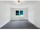 Bedroom with plush carpet, a ceiling fan, fresh paint, and a window overlooking the front yard at 628 Highland Ridge Rd, Mooresville, NC 28115