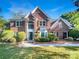 Traditional brick home with symmetrical design, manicured landscaping, and inviting entrance at 628 Highland Ridge Rd, Mooresville, NC 28115