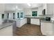 Updated kitchen boasts white cabinets, stainless steel appliances, a center island, and granite countertops at 628 Highland Ridge Rd, Mooresville, NC 28115