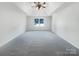 Spacious main bedroom with tray ceiling and large window with backyard views at 628 Highland Ridge Rd, Mooresville, NC 28115