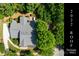 Aerial view of home with mature trees and lush greenery, showing a 2022 roof installation at 6729 Garden Hill Dr, Huntersville, NC 28078
