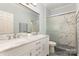 Bright bathroom with double vanity, marble tile, and glass-enclosed shower at 6729 Garden Hill Dr, Huntersville, NC 28078