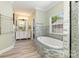 Bright bathroom with a soaking tub, shower, and double vanity at 6729 Garden Hill Dr, Huntersville, NC 28078
