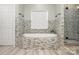 Elegant bathroom featuring a large soaking tub with mosaic surround and a glass-enclosed shower at 6729 Garden Hill Dr, Huntersville, NC 28078