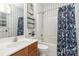 Cozy bathroom featuring a vanity, toilet, bathtub, and a charming floral shower curtain at 6729 Garden Hill Dr, Huntersville, NC 28078