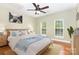 Cozy bedroom features a ceiling fan, hardwood floors, and two windows at 6729 Garden Hill Dr, Huntersville, NC 28078