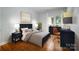 Well-lit bedroom with a ceiling fan, hardwood floors, and workspace at 6729 Garden Hill Dr, Huntersville, NC 28078