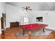 Virtual rendering of a bonus room with a pool table, hardwood floors, and a doorway to the upper floor at 6729 Garden Hill Dr, Huntersville, NC 28078