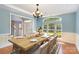 Elegant dining room with large windows, hardwood floors, and ample space for hosting gatherings at 6729 Garden Hill Dr, Huntersville, NC 28078