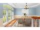 Elegant dining room with large windows and a stylish chandelier at 6729 Garden Hill Dr, Huntersville, NC 28078