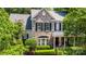 Charming brick two-story home featuring classic black shutters and manicured landscaping at 6729 Garden Hill Dr, Huntersville, NC 28078