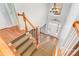 Elegant foyer featuring hardwood floors and a staircase with carpeted steps at 6729 Garden Hill Dr, Huntersville, NC 28078