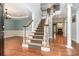 Elegant foyer with hardwood floors and a staircase leading to the upper level at 6729 Garden Hill Dr, Huntersville, NC 28078