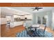 Open concept kitchen featuring white cabinetry, granite countertops, and seamless access to the sunroom at 6729 Garden Hill Dr, Huntersville, NC 28078