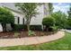 Beautifully landscaped walkway with manicured bushes and decorative elements at 6729 Garden Hill Dr, Huntersville, NC 28078