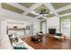 Open-concept living room with a fireplace, hardwood floors, and views of the modern kitchen with white cabinets at 6729 Garden Hill Dr, Huntersville, NC 28078